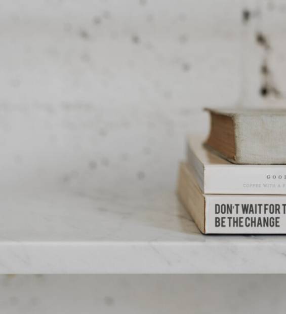 Stack of psychology books on a white marble shelf